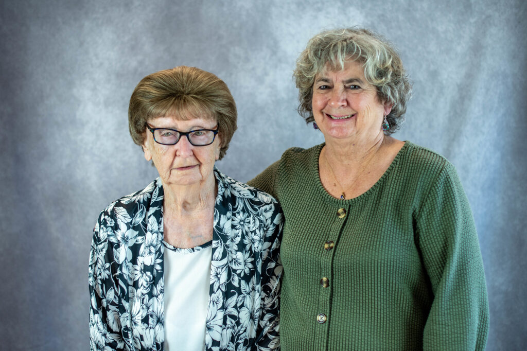 A pair of senior women posing for a photo