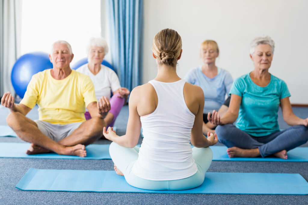 a yoga class full of seniors with an instructor