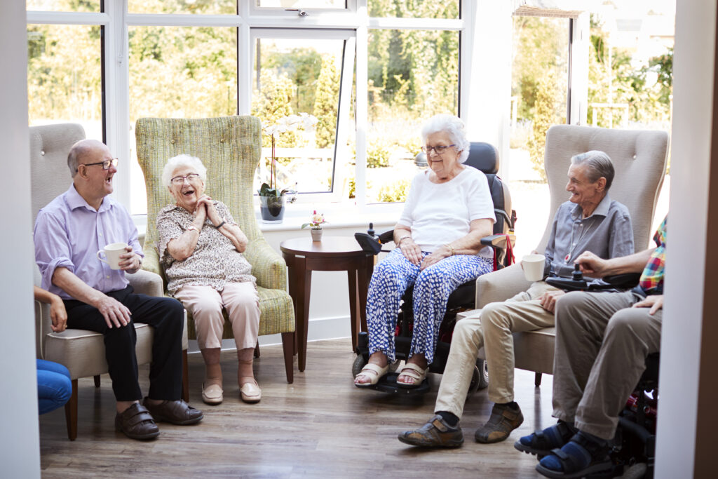 Group of seniors sitting in a circle and laughing