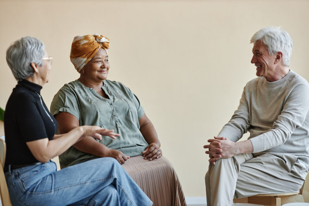 senior people sitting in circle at a support group