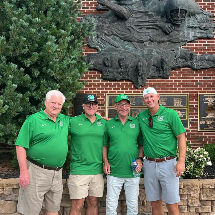 Bobby Petras with three others after a football game outside of the stadium.