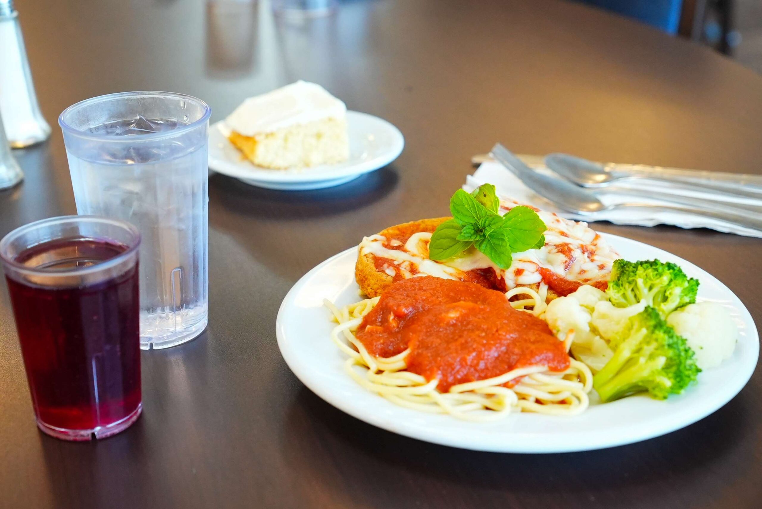 Chicken parmesean and spaghetti, with a side of broccali and cauliflower.