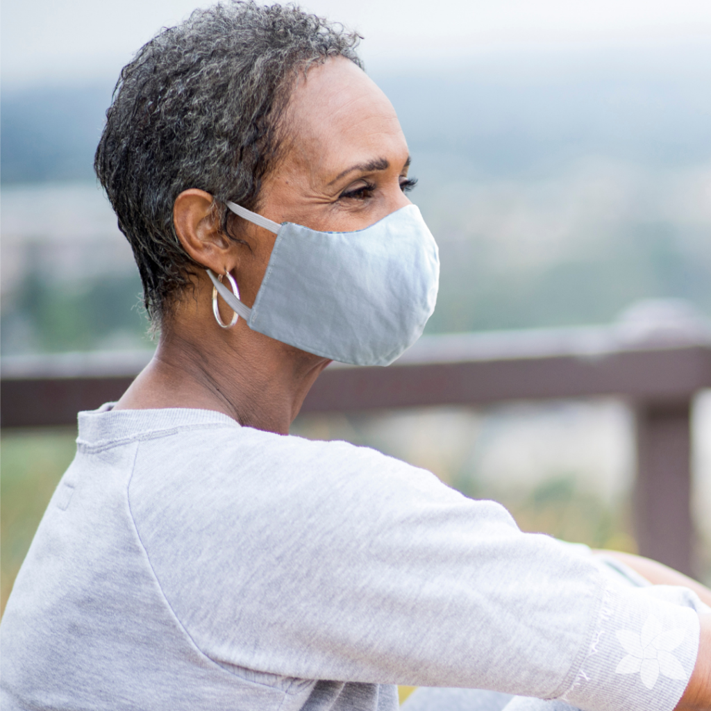 Senior woman wearing a mask and looking out in the distance