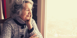 Senior woman smiling and looking out a window