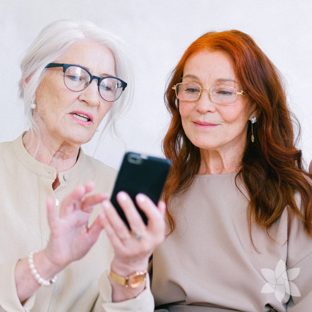 Two senior women looking at a cellphone