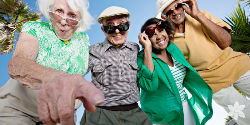 A group of seniors wearing sunglasses and smiling