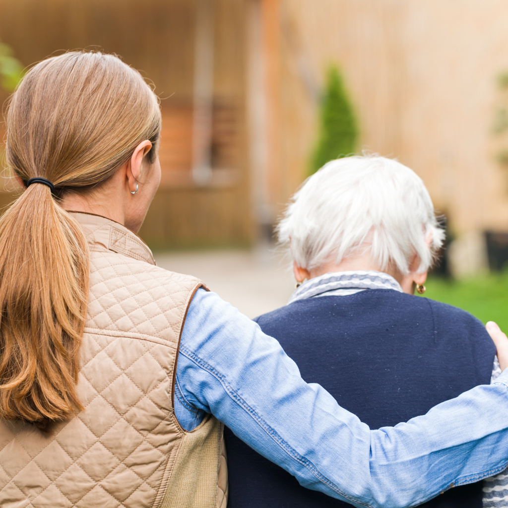 Caregiver holding the shoulders of senior person